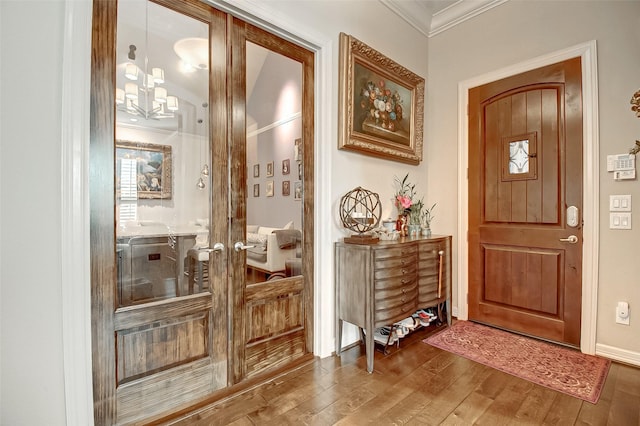 entryway with crown molding, hardwood / wood-style floors, and french doors