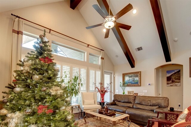 living room with beamed ceiling, plenty of natural light, and high vaulted ceiling