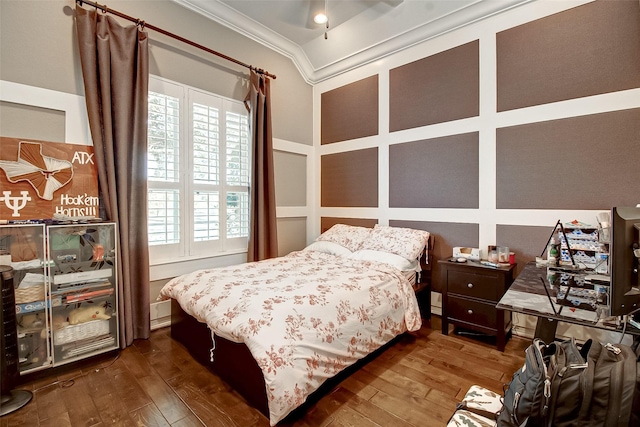 bedroom with ornamental molding and wood-type flooring