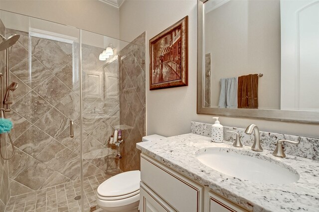 bathroom with vanity, toilet, and a shower with door