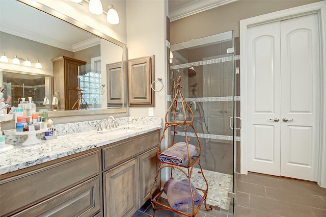 bathroom with a stall shower, tile patterned floors, crown molding, and vanity