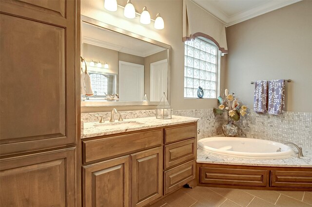 bathroom with tile patterned flooring, a bathtub, crown molding, and vanity