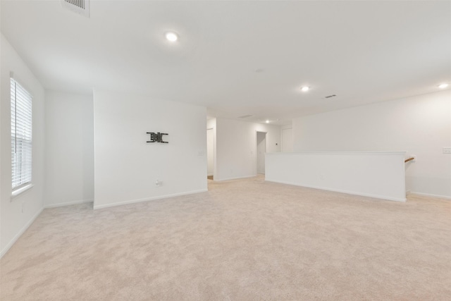 unfurnished room with light colored carpet