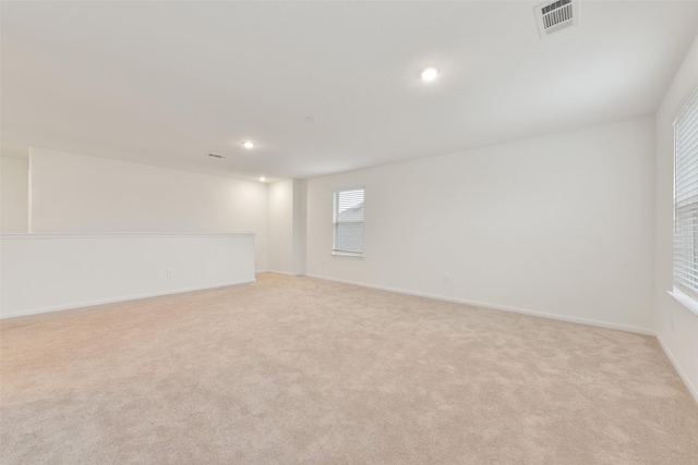 spare room with light colored carpet