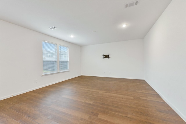 empty room with hardwood / wood-style flooring