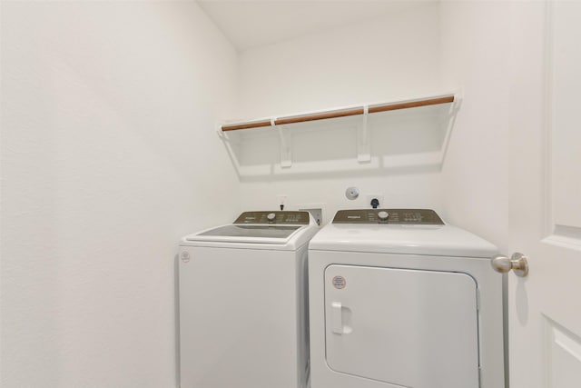 washroom with washing machine and clothes dryer