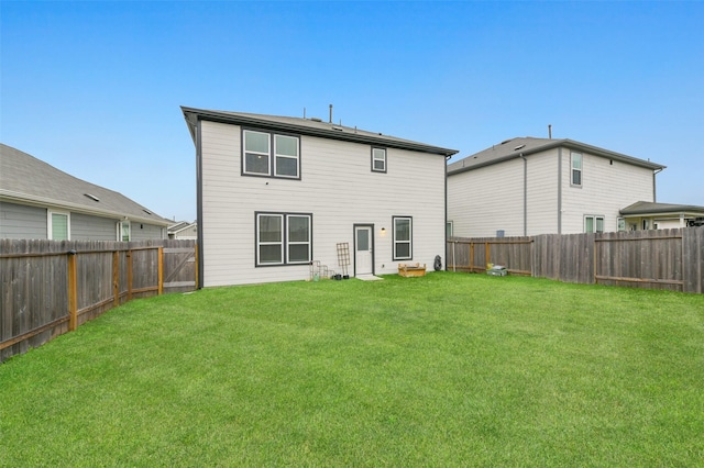 rear view of house featuring a lawn