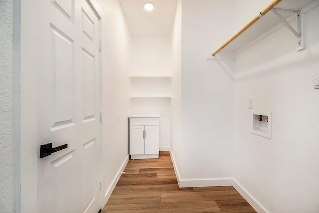 clothes washing area with washer hookup and light hardwood / wood-style flooring