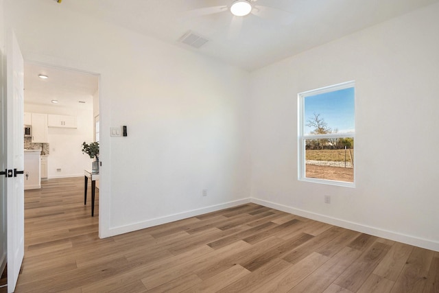 unfurnished room with light hardwood / wood-style floors and ceiling fan