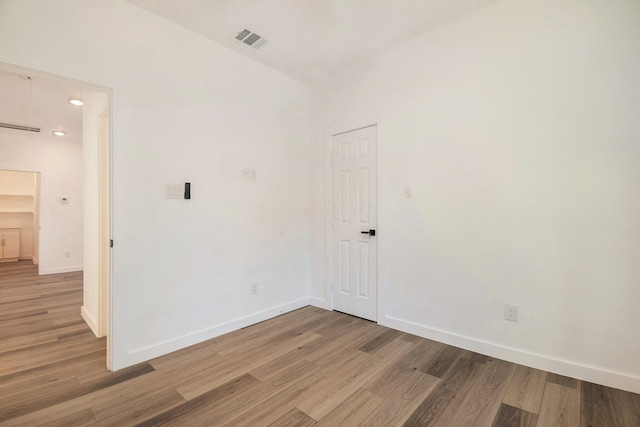 unfurnished room with wood-type flooring