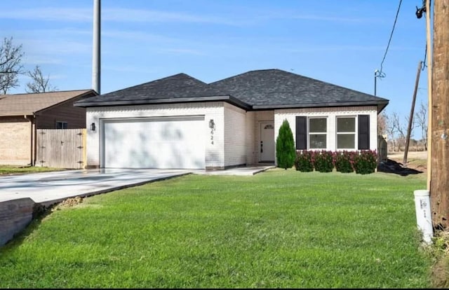 ranch-style house with a garage and a front lawn