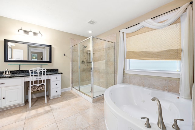 bathroom featuring independent shower and bath, vanity, and tile patterned flooring