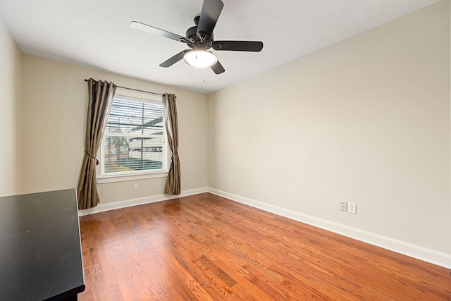 spare room with hardwood / wood-style flooring and ceiling fan