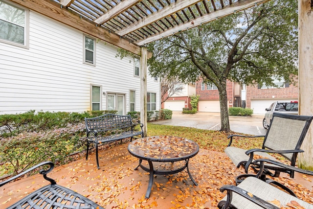 view of patio with a garage and a pergola