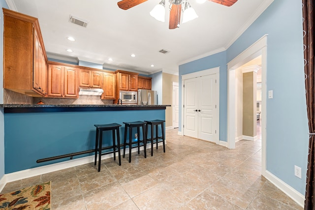 kitchen with crown molding, ceiling fan, appliances with stainless steel finishes, decorative backsplash, and kitchen peninsula