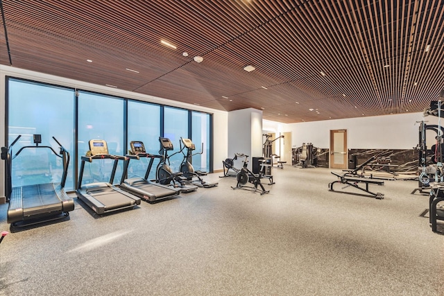 exercise room with wood ceiling and expansive windows