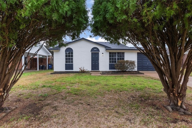 ranch-style house featuring a garage and a front yard