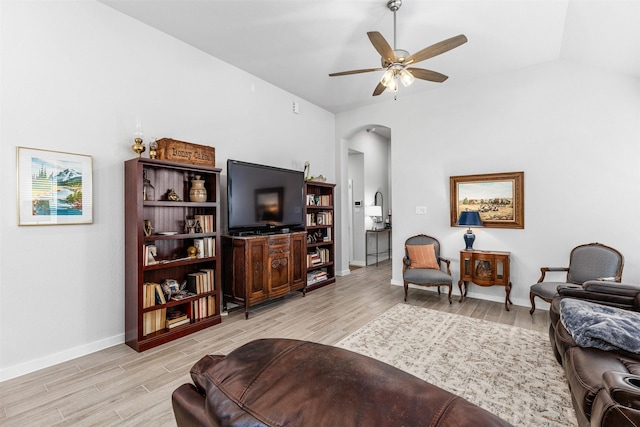 living room featuring ceiling fan, vaulted ceiling, and light hardwood / wood-style flooring