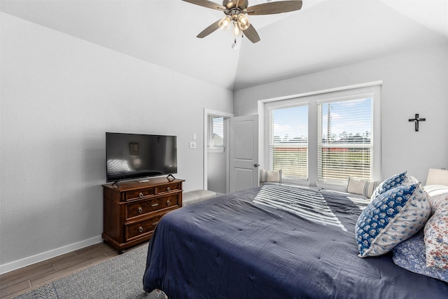 bedroom featuring hardwood / wood-style flooring, vaulted ceiling, and ceiling fan