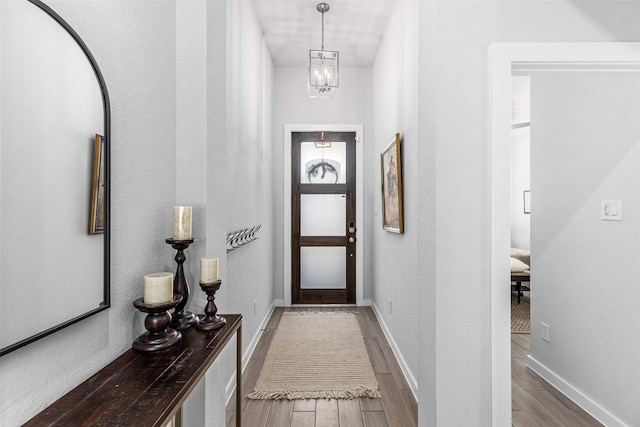 interior space with an inviting chandelier and wood-type flooring