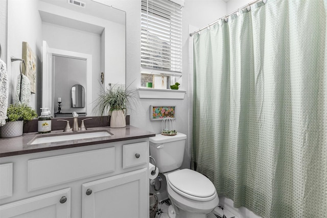 full bathroom with vanity, shower / bath combination with curtain, and toilet