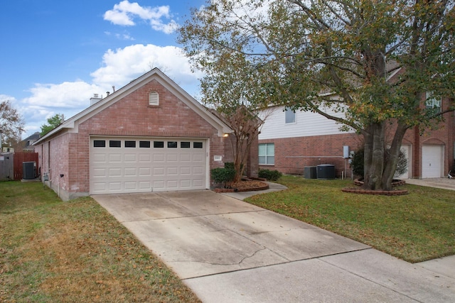 front facade featuring cooling unit, a garage, and a front lawn