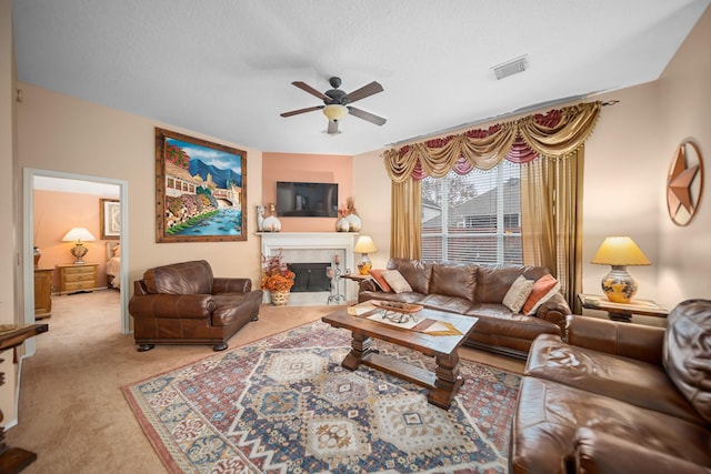 living room with a textured ceiling, ceiling fan, and carpet flooring