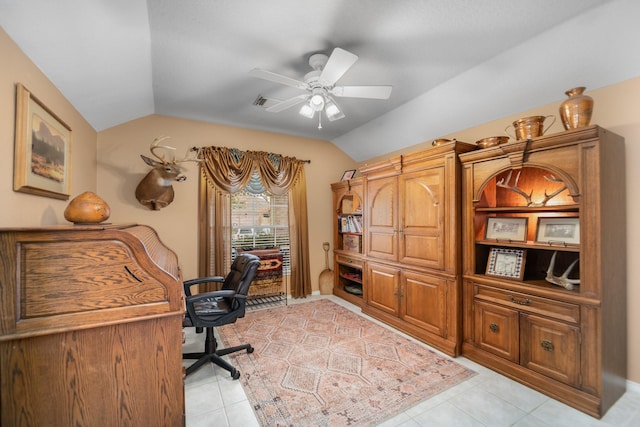 home office with lofted ceiling, light tile patterned floors, and ceiling fan