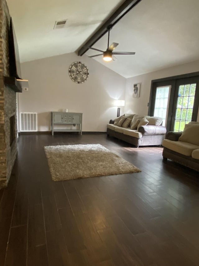 unfurnished living room featuring dark hardwood / wood-style flooring, vaulted ceiling with beams, a fireplace, and ceiling fan