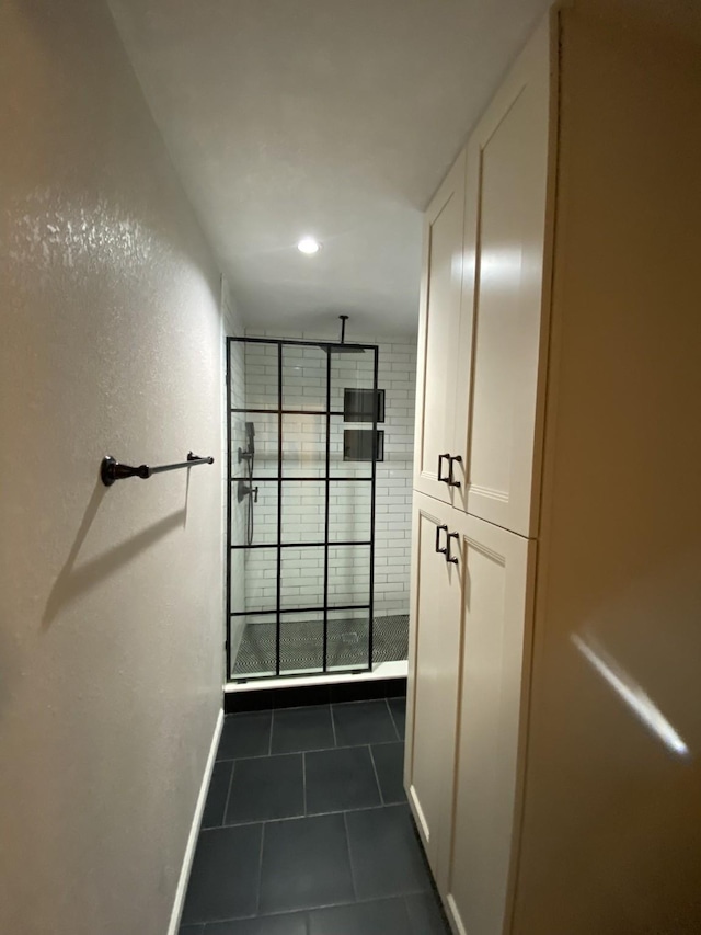 walk in closet featuring dark tile patterned flooring