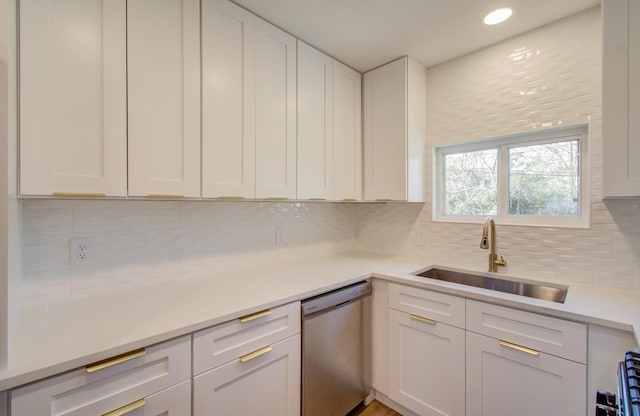 kitchen with white cabinetry, dishwasher, sink, and decorative backsplash