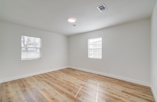 unfurnished room featuring light hardwood / wood-style floors