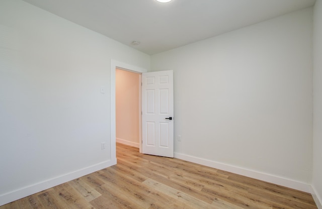 spare room with light hardwood / wood-style flooring