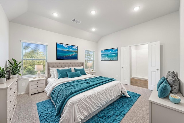 bedroom with lofted ceiling and light carpet