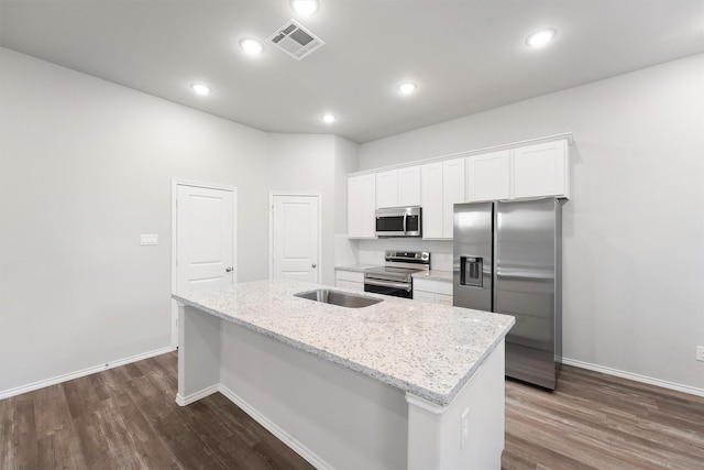 kitchen featuring appliances with stainless steel finishes, white cabinetry, a kitchen island with sink, light stone counters, and dark wood-type flooring