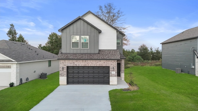 view of front of property featuring cooling unit, a garage, and a front yard