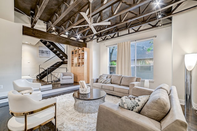 living room with hardwood / wood-style flooring, a baseboard radiator, and a high ceiling