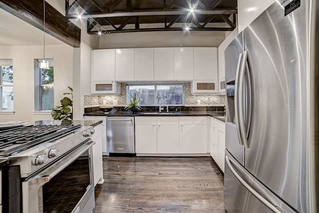 kitchen featuring sink, tasteful backsplash, dark hardwood / wood-style floors, stainless steel appliances, and white cabinets