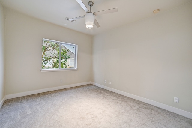 carpeted spare room with ceiling fan