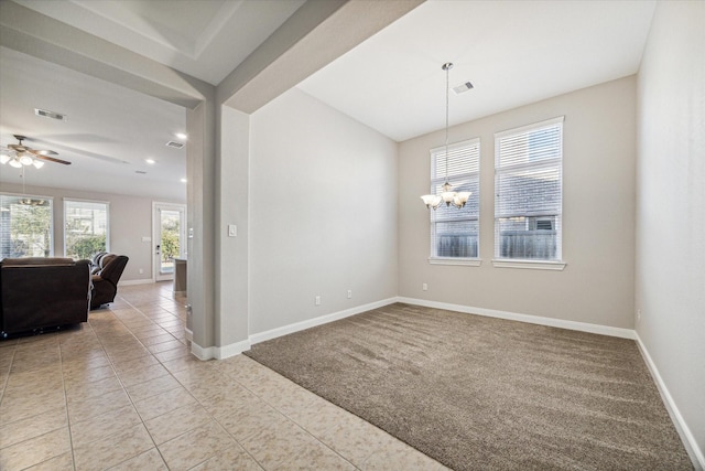 tiled empty room featuring ceiling fan with notable chandelier