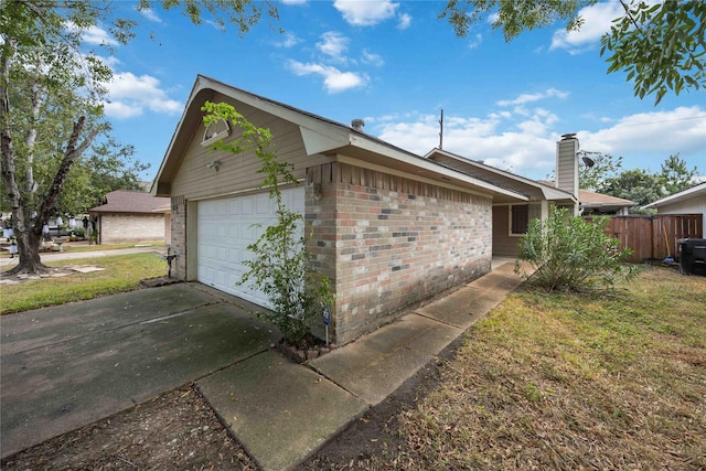 view of property exterior with a garage and a lawn