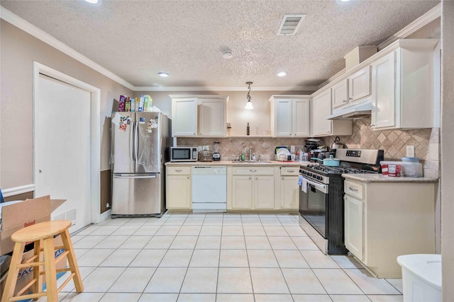 kitchen with white cabinetry, appliances with stainless steel finishes, sink, and pendant lighting