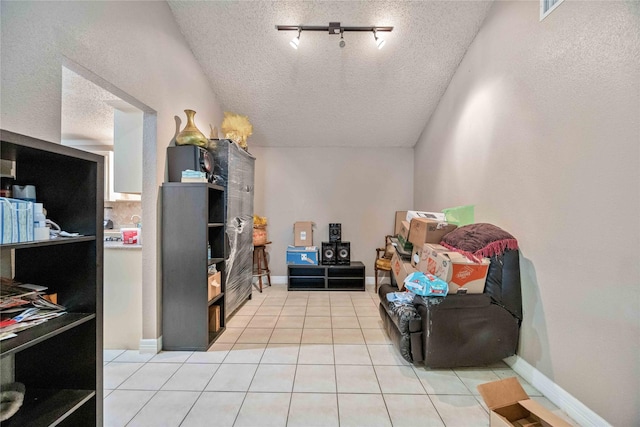 living area featuring light tile patterned floors and a textured ceiling