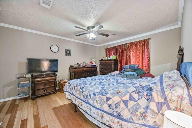 bedroom with crown molding, ceiling fan, a textured ceiling, and light hardwood / wood-style floors