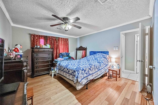 bedroom with crown molding, ceiling fan, wood-type flooring, and a textured ceiling