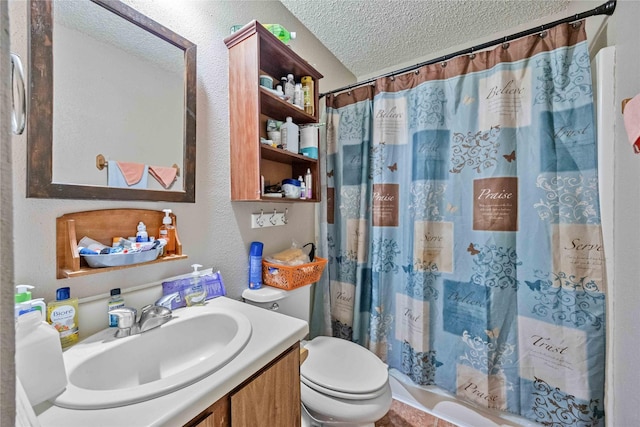 bathroom featuring vanity, a textured ceiling, and toilet