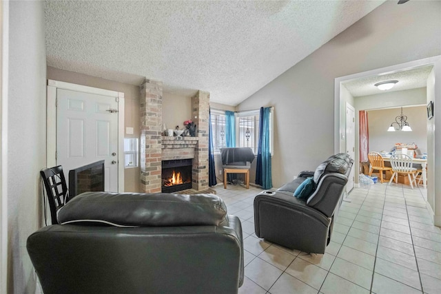 living room with lofted ceiling, a brick fireplace, light tile patterned floors, and a textured ceiling