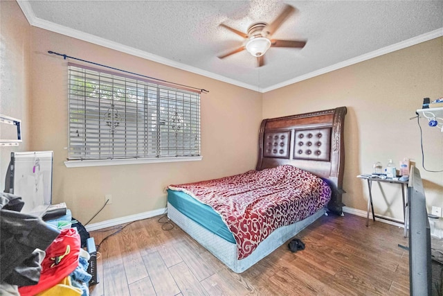 bedroom with hardwood / wood-style flooring, ceiling fan, ornamental molding, and a textured ceiling