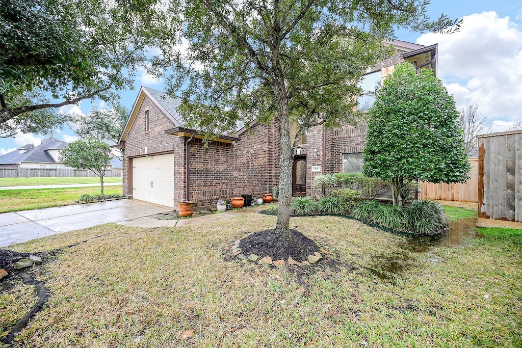 view of front of home featuring a garage and a front lawn