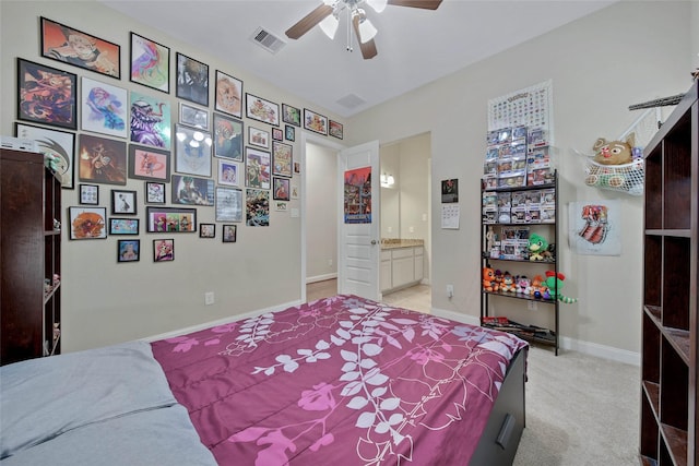 carpeted bedroom featuring ceiling fan and connected bathroom